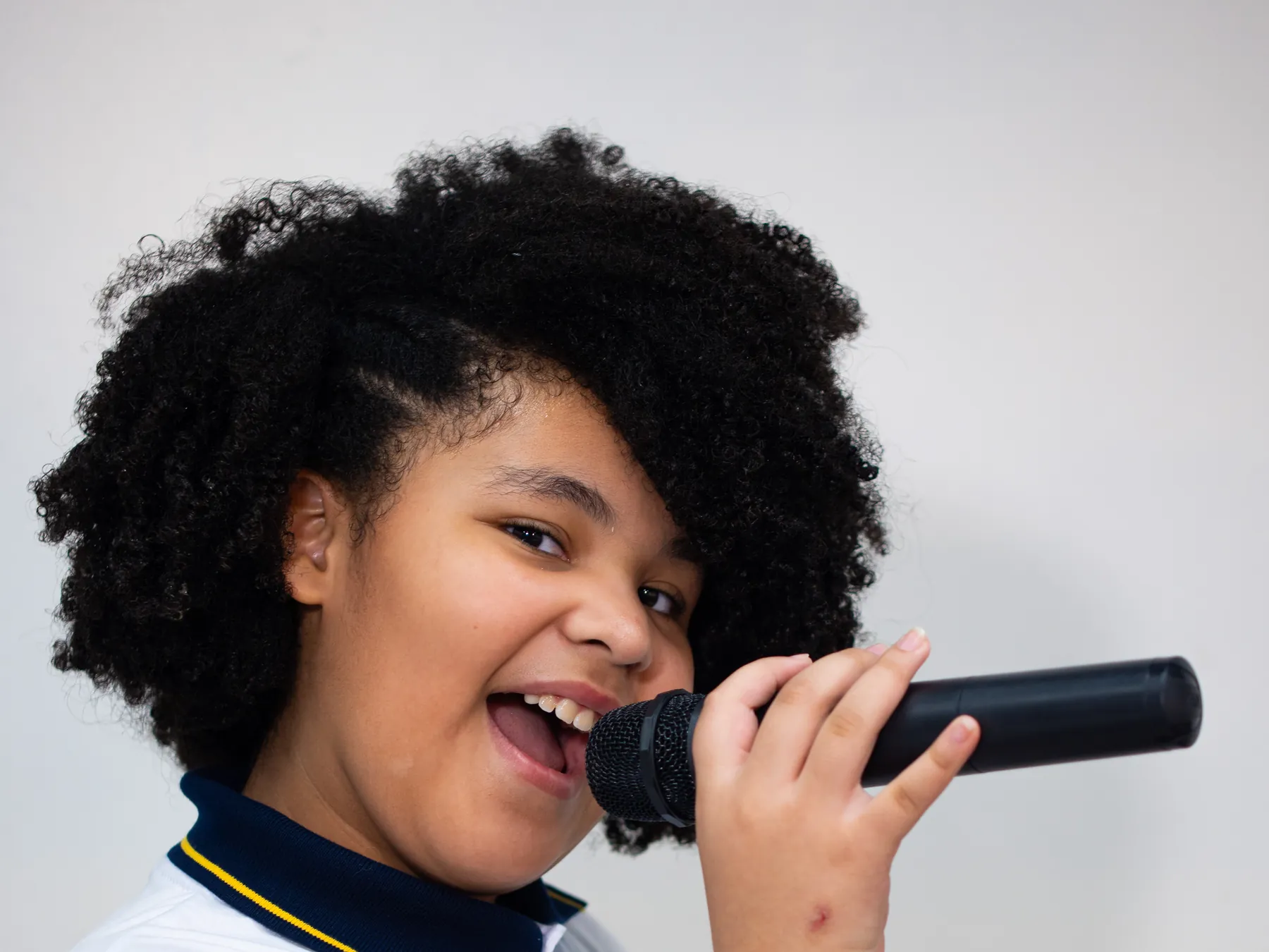 Aluna do Palas Atena cantando ao microfone